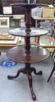 A George III three tier dumb waiter, raised on a tripod base and pad feet  42"h  22"dia at the