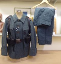 A World War II design German military uniform, on a manikin  34"h Military uniforms: to include  (