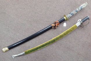 A modern Japanese sword, the curved blade 28"L in a scabbard; and a contemporary sabre, the curved