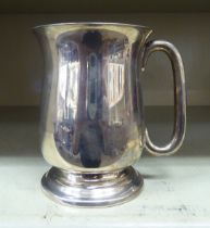 A silver half-pint tankard, on a pedestal foot  Birmingham 1943