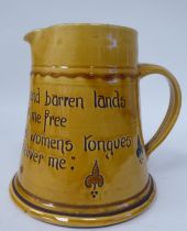 A West Country yellow glazed pottery ale jug of tapered form, inscribed  'From rocks and Lands and