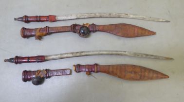 Two North African swords, each with a hide scabbard  24"h