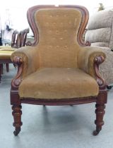 A mid Victorian mahogany showwood framed spoonback chair, part button upholstered in stone