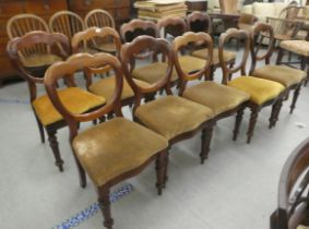 A set of ten mid Victorian mahogany framed balloon back dining chairs, upholstered in sand