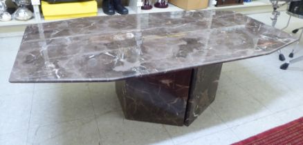 A modern reconstructed marble effect coffee table of elongated octagonal form  16"h  49"w