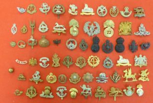 Approx. fifty military and associated cap badges and uniform insignia, some copies: to include