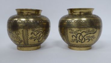 A pair of late 19thC Chinese bronze, bulbous footed vases, engraved in panels with floral and