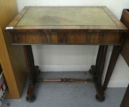 A William IV rosewood writing table with a frieze drawer, raised on three turned pillars, on a