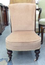 A late 19thC gold fabric upholstered nursing chair, raised on walnut, turned, tapered legs