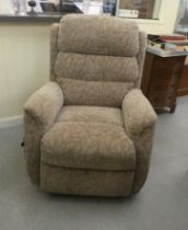 A modern Care Co recliner chair with remote control and stone coloured upholstery, on casters