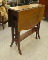 An Edwardian satinwood inlaid mahogany Sutherland table, the top with fall flaps, raised on splayed,