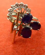 A bi-coloured metal ring, tiered with diamonds and sapphires