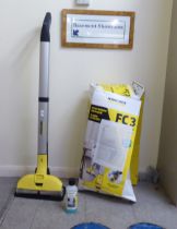 A Karcher FC3 cordless floor cleaner with box and accessories  47"h