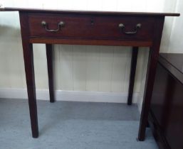 An early 19thC mahogany side table, the overhanging top above a frieze drawer with twin brass bail