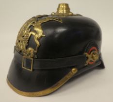 A German black hide and brass mounted pickelhaube with a liner (Please Note: this lot is subject