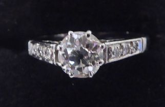 A white coloured metal, single stone, claw set diamond ring with diamond shoulders  stamped Plat