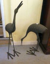 Two patinated cast metal garden ornaments, standing cranes  24"h  36"w