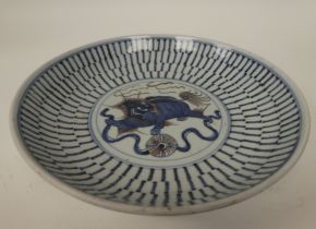 A 19thC Chinese provincial footed porcelain dish, decorated in blue, brown and white with a dragon-