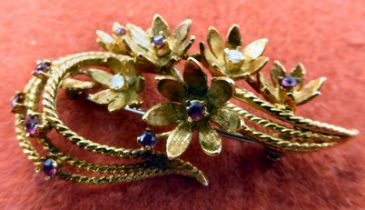 A yellow metal floral spray design brooch, set with diamonds and rubies