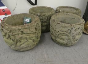 A set of four composition stone planters, decorated with a forest scene  10"h  12"dia