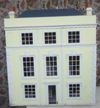 A 20thC Georgian design, yellow and white painted, three storey doll's townhouse,