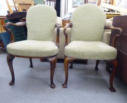A pair of mid 19thC walnut framed open arm chairs, raised on cabriole legs