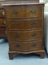 A modern walnut veneered serpentine front dressing chest with four drawers, raised on bracket