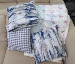 Variously patterned scatter cushions; and a quilt