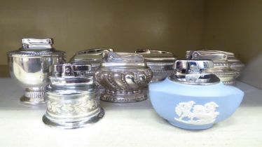 Seven silver plated table lighters, one in powder blue Wedgwood jasperware, some by Ronson
