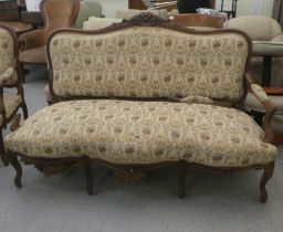 An early to mid 20thC French inspired mahogany framed showwood two person open arm settee,