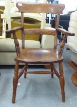 A late 19thC beech and elm framed, low round back Windsor armchair, the solid seat raised on turned,