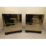 A pair of modern mirrored two drawer bedside cabinets, raised on bracket feet  21"h  18"w