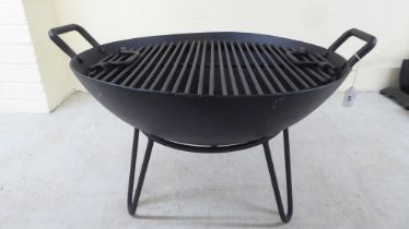 A cast iron combination fire pit/bbq  16'h  23''dia