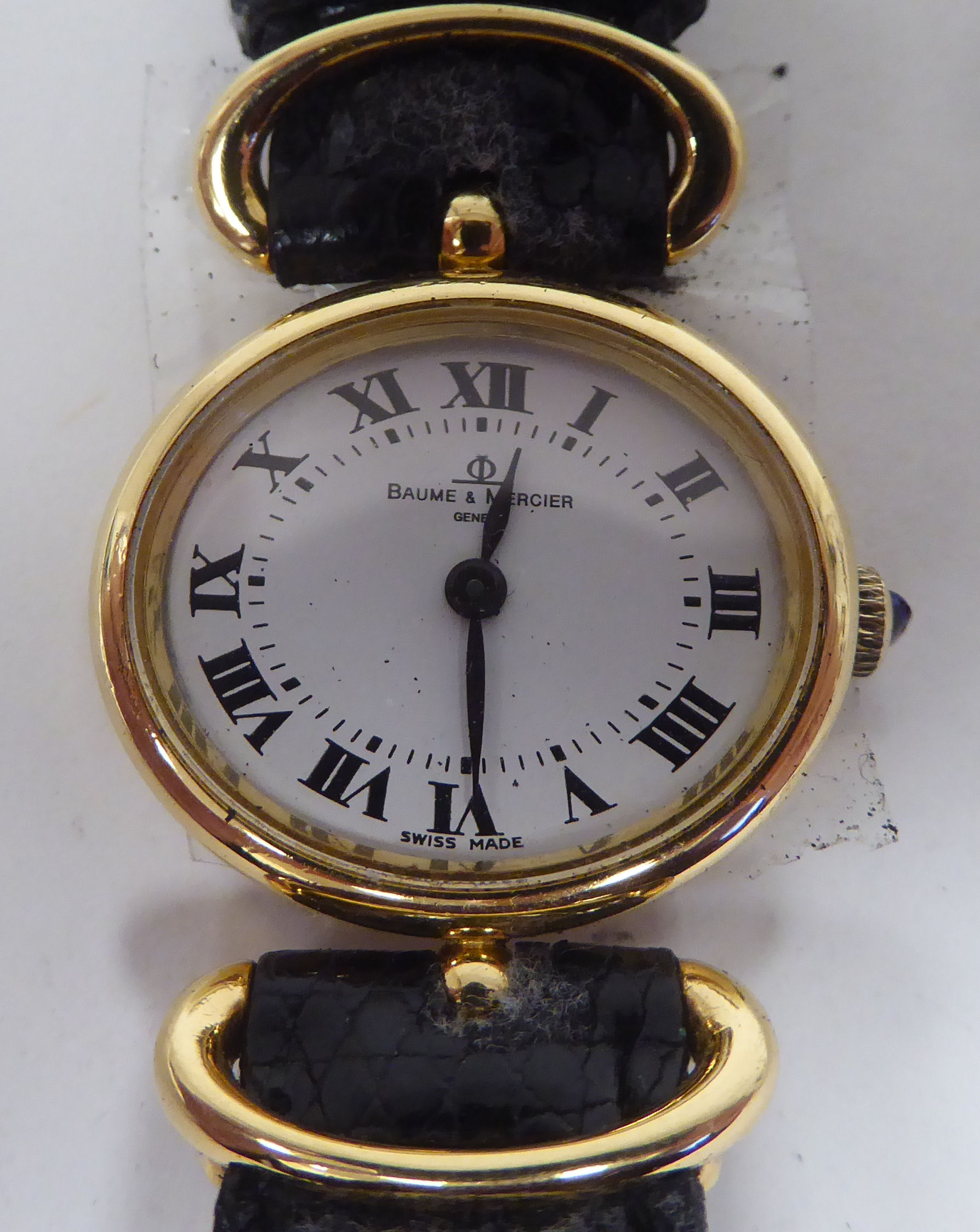 A lady's Baume & Mercia 18ct gold oval cased wristwatch, on a black hide strap