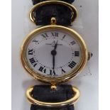 A lady's Baume & Mercia 18ct gold oval cased wristwatch, on a black hide strap