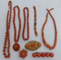 Coral coloured, turned and finished items of personal ornament