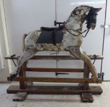 An early 20thC overpainted, hand carved, pine rocking horse  50"h