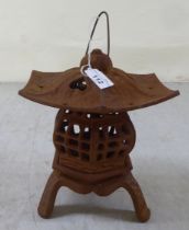 A rust coloured cast iron, pagoda design tealight holder  8"h