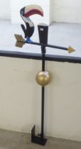 A modern painted, cast iron weather vane, surmounted by a Guinness Toucan