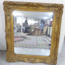 A 20thC mirror, the plate set in a moulded gilt frame  28" x 31"