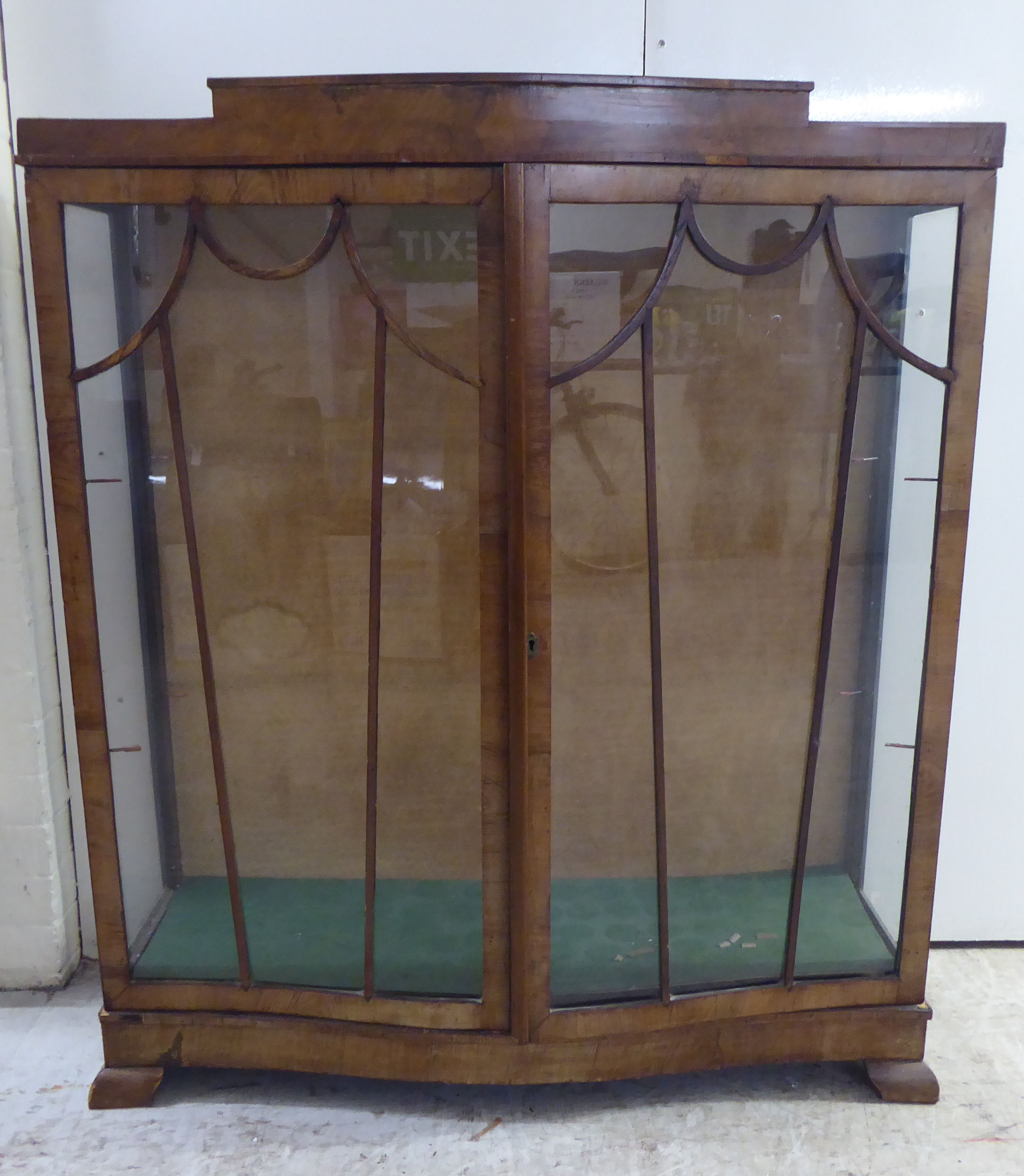 An Art Deco walnut finished display cabinet, raised on bracket feet  48"h  40"w