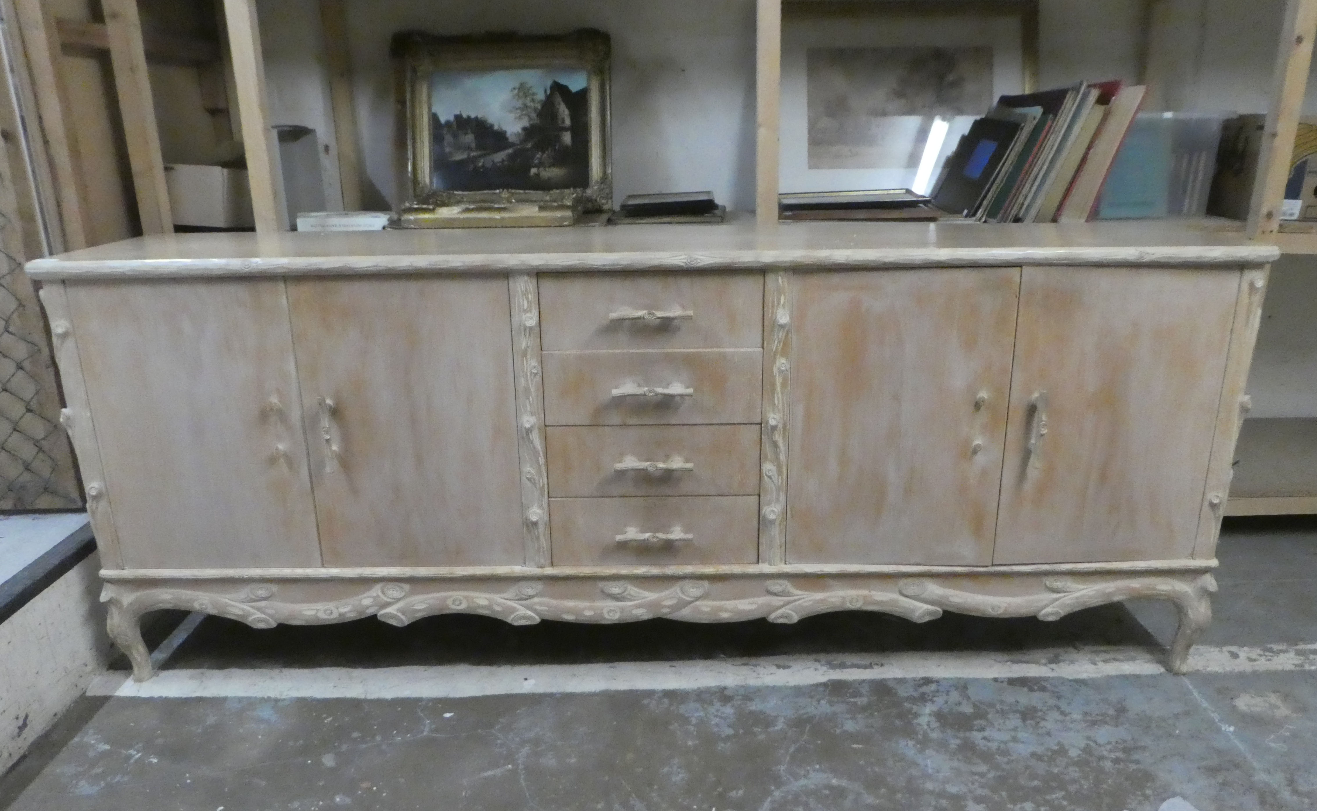 A modern French hunting lodge style, naturally carved, bleached light oak sideboard with a central