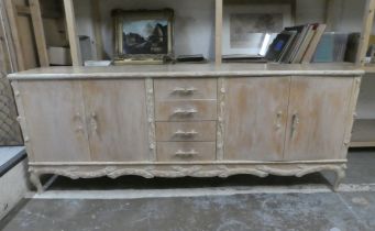 A modern French hunting lodge style, naturally carved, bleached light oak sideboard with a central