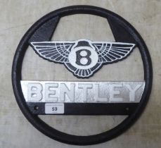 A painted cast iron sign 'Bentley'  11"dia