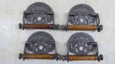 A set of four novelty cast iron toilet roll holders, branded for 'GWR'  5"w