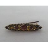 A 9ct gold brooch, decorated with flora and set with round cut stones