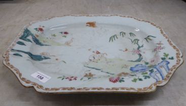 An 18thC Chinese porcelain meat plate, decorated with a landscape  17"dia