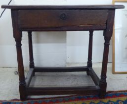 A George III oak single drawer side table, raised on turned and block legs  25"h  27"w