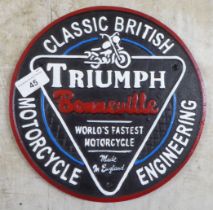 A painted cast iron sign 'Triumph'  9.5"dia