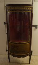 A 20thC reproduction of an 18thC European inspired stained beech corner vitrine with gilt metal